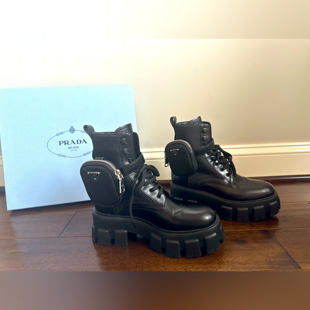 Prada 
Monolith brushed leather and nylon boots with 2 pouches.